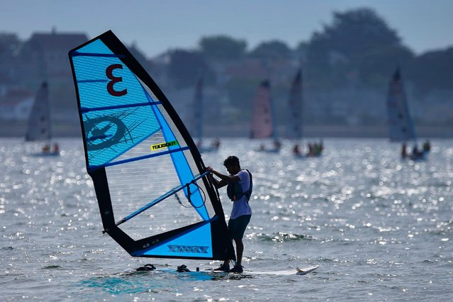 A Community Boating student works on his windsurfing skills on Clarks Cove in New Bedford, Mass. on August 9, 2024. (Photo by Peter Pereira/The Standard-Times via USA TODAY Network)