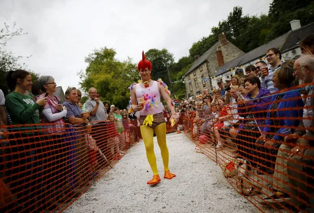 Competitor Matt Beech walks the track before his hen's heat during the World Championship Hen Racing Championships in Bonsall, Britain, August 1, 2015. (Photo by Darren Staples/Reuters)