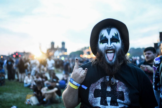 A heavy metal fan gestures as he attends a concert during the Hellfest Summer Open Air rock festival in Clisson, western France, on June 15, 2023. (Photo by Sebastien Salom-Gomis/AFP Photo)