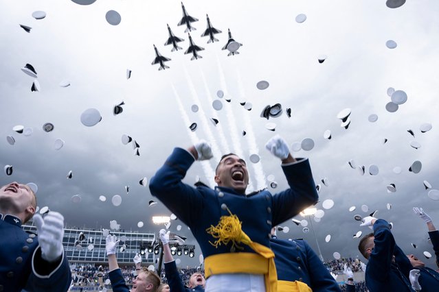 Cadets celebrate during their graduation ceremony at the United States Air Force Academy, just north of Colorado Springs in El Paso County, Colorado, on June 1, 2023. (Photo by Brendan Smialowski/AFP Photo)