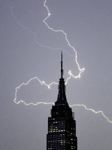 Lighting strikes over the Empire State Building in New York on July 2, 2014. (Photo by Timothy A. Clary/AFP Photo)