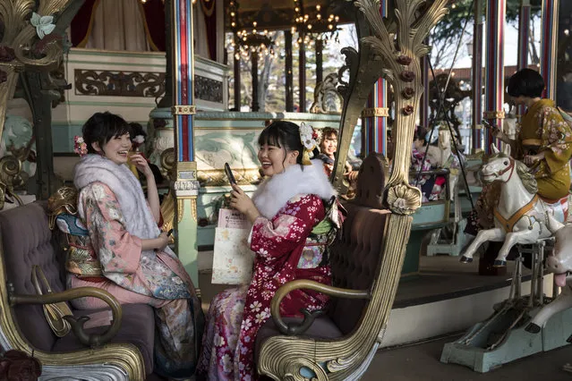 Women wearing kimonos ride a merry-go-round after attending a Coming of Age ceremony at the Toshimaen amusement park on January 13, 2020 in Tokyo, Japan. (Photo by Tomohiro Ohsumi/Getty Images)