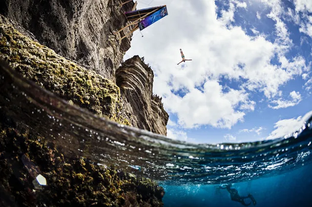 In this handout image provided by Red Bull, Anna Bader of Germany dives from the 21 metre platform on Islet Franca do Campo during the second stop of Red Bull Cliff Diving World Series on July 9, 2017 in Sao Miguel, Azores, Portugal. (Photo by Samo Vidic/Red Bull via Getty Images)