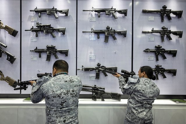 Philippine navy personnel check rifles on display during the Asian Defense and Security Exhibition at World Trade Center, Pasay City, Metro Manila, Philippines on September 25, 2024. (Photo by Eloisa Lopez/Reuters)