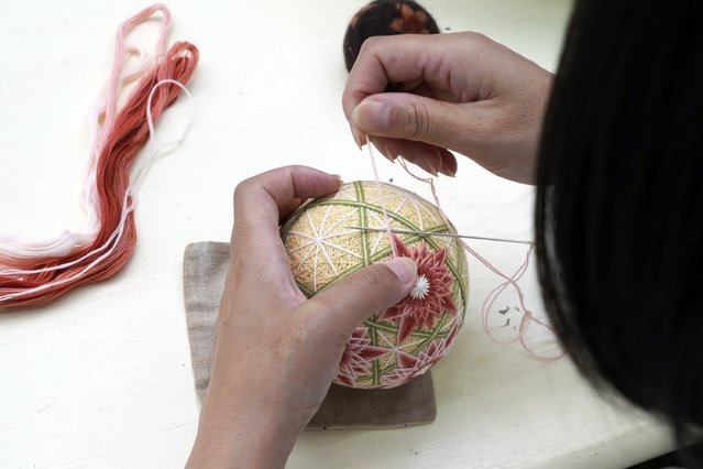  A staff member works on the temari at Sanuki Kagari Temari in Kawaramachi, Kagawa prefecture, Japan, on September 5, 2024. (Photo by Ayaka McGill/AP Photo)