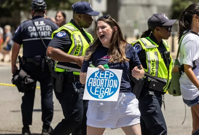 Abortion rights activists are detained by the U.S. Capitol police after they blocked an intersection near the United States Supreme Court to protest the court's ruling to overturn the landmark Roe v Wade abortion decision, in Washington, U.S., June 30, 2022. (Photo by Evelyn Hockstein/Reuters)
