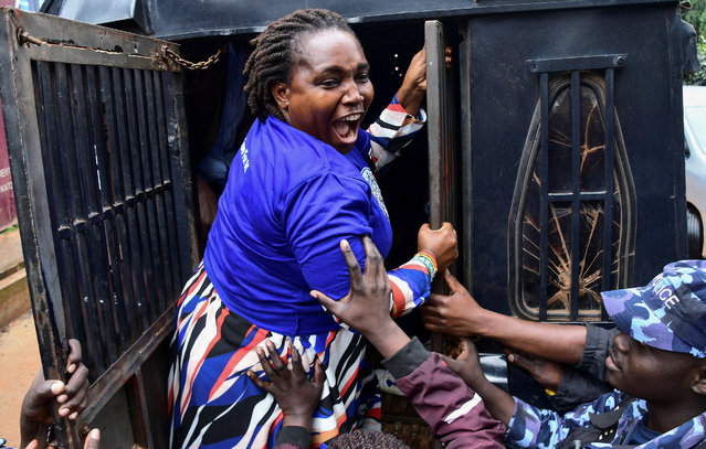 Ugandan police officers detain a supporter of opposition leader Kizza Besigye, who was abducted in neighbouring Kenya on November 16, during a march to the Kenya High Commission in Uganda, in Kampala, Uganda on November 25, 2024. (Photo by Abubaker Lubowa/Reuters)