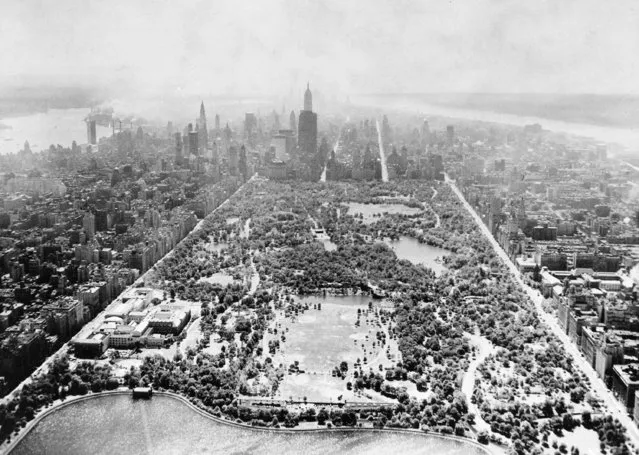 This aerial view shows two-thirds of Central Park's 40 acres, looking south toward the tip of Manhattan, on August 26, 1957.  In the foreground is part of the billion-gallon reservoir, and the open space above contains six baseball diamonds. At left along Fifth Ave., is the Metropolitan Museum of Art. The tall skyscraper in the center is the Empire State Building. (Photo by AP Photo)