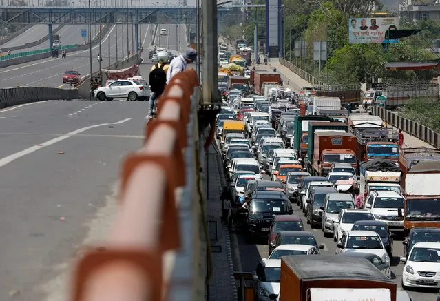 Vehicles queue in a long traffic jam at Delhi-Ghaziabad border after local authorities stopped vehicular movement except for essential services during an extended lockdown to slow the spreading of coronavirus disease (COVID-19) in New Delhi, April 21, 2020. (Photo by Adnan Abidi/Reuters)