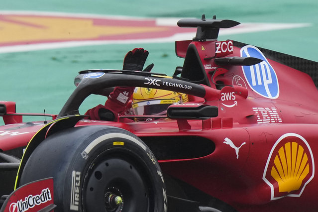 British driver Lewis Hamilton waves to fans as he steers a Ferrari Formula One SF-23 at the Ferrari private test track, in Fiorano Modenese, Italy, Wednesday, January 22, 2025. (Photo by Luca Bruno/AP Photo)