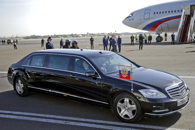 Russian President Vladimir Putin sits in the back seat of his limousine, on his arrival to Mehrabad Airport, in Tehran, Iran, Wednesday, November 1, 2017. Putin arrived in Iran for trilateral talks with Tehran and Azerbaijan. (Photo by Ebrahim Noroozi/AP Photo)