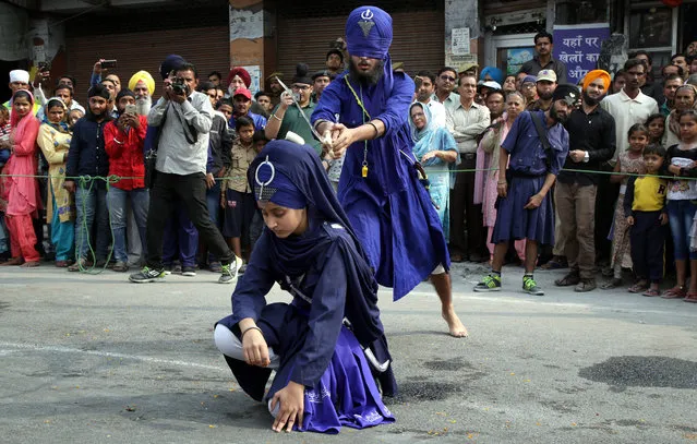 India Sikh devotees show their skills as they take part in a religious procession ahead of the birth anniversary of the first Sikh Guru or master, Sri Guru Nanak Dev Ji, the founder of Sikhism, in Jammu, the winter capital of Kashmir, India, 01 November 2017. The birth anniversary of Guru Nanak Dev Ji will be observed on 04 November 2017. (Photo by Jaipal Singh/EPA/EFE)