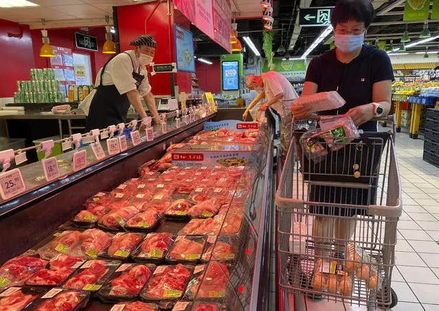 A resident wearing a face mask to curb the spread of the coronavirus browses meat products at a supermarket in Beijing, Monday, June 15, 2020. China's capital was bracing Monday for a resurgence of the coronavirus after more than 100 new cases were reported in recent days in a city that hadn't seen a case of local transmission in more than a month. (Photo by Ng Han Guan/AP Photo)
