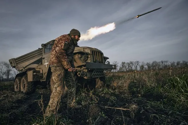 Ukrainian military's Grad multiple rocket launcher fires rockets at Russian positions in the frontline near Bakhmut, Donetsk region, Ukraine, Thursday, November 24, 2022. (Photo by LIBKOS/AP Photo)