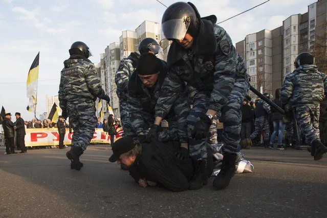 Russian police detain a nationalist activist during the Russian March in Moscow on Tuesday, November 4, 2014. (Photo by Pavel Golovkin/AP Photo)