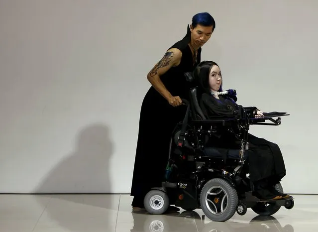 A French model, who is a spinal muscular atrophy patient, is pushed in a wheelchair as she presents a creation by designer Takafumi Tsuruta from his Spring/Summer 2016 collection for his brand tenbo during Tokyo Fashion Week in Tokyo, Japan, October 13, 2015. (Photo by Yuya Shino/Reuters)