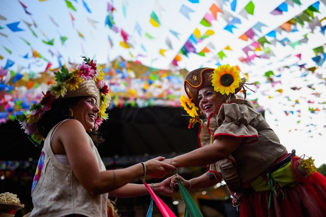 Members of the stilt-walking group Quadrilha de Gigantes perform during the traditional “Festa Junina” celebration at the Feira de Sao Cristovao in Rio de Janeiro, Brazil on June 29, 2025. (Photo by Tita Barros/Reuters)