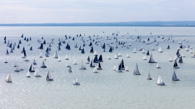 Sailboats compete after the start of the 57th Blue Ribbon round-the-lake international yachting race around Lake Balaton near Balatonfuered, Hungary, 10 July 2025. This year more than 470 sailboats started the 155 kms race. (Photo by Tamas Vasvari/EPA)