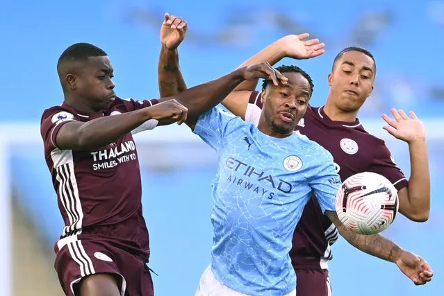 Manchester City's English midfielder Raheem Sterling (C) vies with Leicester City's French midfielder Nampalys Mendy (L) and Leicester City's Belgian midfielder Youri Tielemans (R) during the English Premier League football match between Manchester City and Leicester City at the Etihad Stadium in Manchester, north west England, on September 27, 2020. (Photo by Laurence Griffiths/Pool via AFP Photo)
