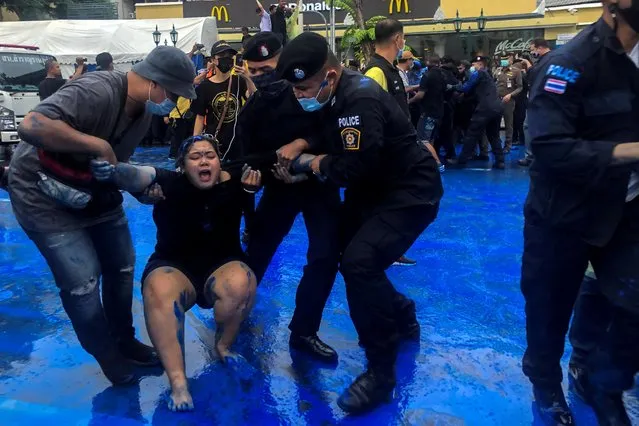 Police officers detain a pro-democracy activist during a protest against government and monarchy near the Democracy Monument in Bangkok, October 13, 2020. (Photo by Kay Johnson/Reuters)