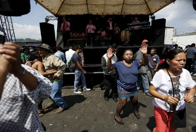 People dance outside of the church in honor of San Simon in Iztapa, in Chimaltenango, around 62 km (39 miles), from Guatemala City, October 28, 2015. (Photo by Jorge Dan Lopez/Reuters)