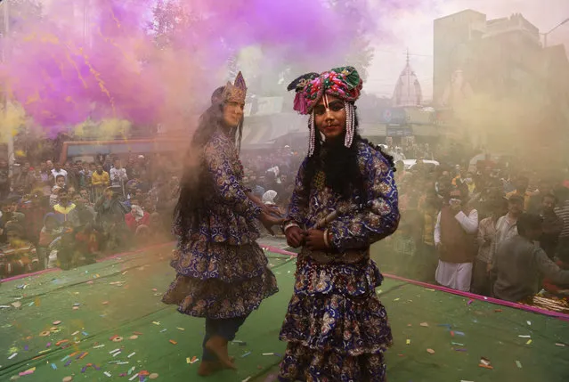 Indians dressed as Hindu deities Radha, center, and Krishana play Holi in Jammu, India, Thursday March 1, 2018. (Photo by Channi Anand/AP Photo)