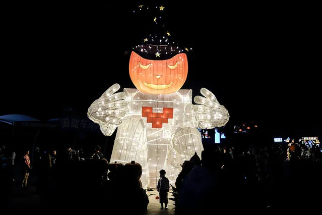 A child carries a pumpkin lantern during the Parade event of a celebration for Halloween at the Happy Valley on October 29, 2020 in Wuhan, Hubei province, China. As there have been no recorded cases of community transmissions since May, life for residents is gradually returning to normal. (Photo by Getty Images/China Stringer Network)