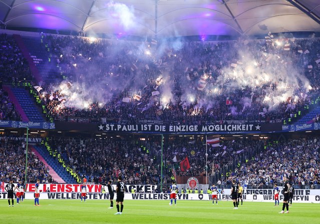 Fans of FC St. Pauli burn flares during the Bundesliga soccer match between Hamburger SV and FC St. Pauli, in Hamburg, Germany, 29 August 2025. (Photo by Hannibal Hanschke/EPA)