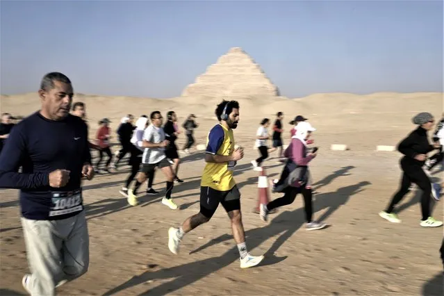Runners participate in the (10km, 6.2 mile) Saqqara Pyramid Race at the site of the Step Pyramid of Djoser in Saqqara, southwest of Cairo, Egypt, Friday, February 17, 2023. (Photo by Amr Nabil/AP Photo)