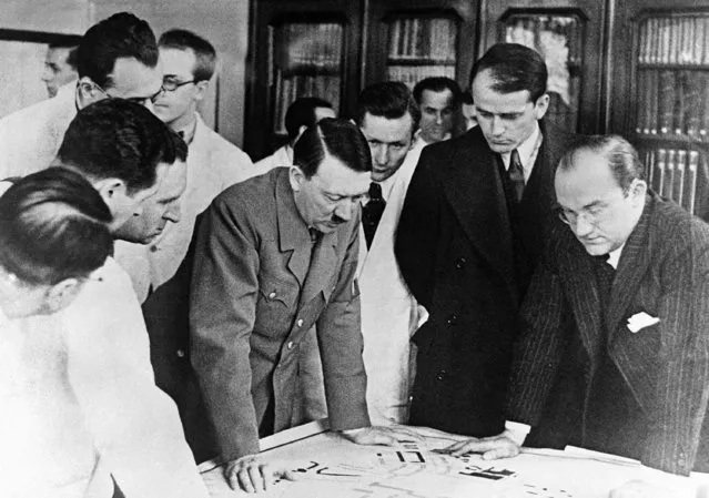 German Chancellor Adolf Hitler paid a short visit to Nuremberg and inspected the plans and a model of the new Congress Hall which will be erected at Nuremberg for Nazi party congresses. Adolf Hitler examining the plans of the new party buildings, in Nuremberg, on February 24, 1937. German architect, Professor Albert Speer, second right, looks at the drawings. (Photo by AP Photo)