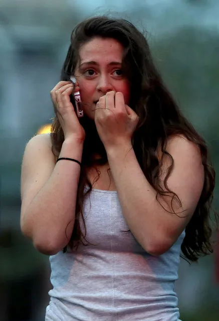 Resident Rosie Meyer, who said she heard gunshots, reacts while watching police respond on April 19, 2013 in Watertown, Massachusetts. After a car chase and shoot out with police, one suspect in the Boston Marathon bombing, Tamerlan Tsarnaev, 26, was shot and killed by police early morning April 19, and a manhunt is underway for his brother and second suspect, 19-year-old suspect Dzhokhar A. Tsarnaev. The two men, reportedly Chechen of origin, are suspects in the bombings at the Boston Marathon on April 15, that killed three people and wounded at least 170.  (Photo by Mario Tama)