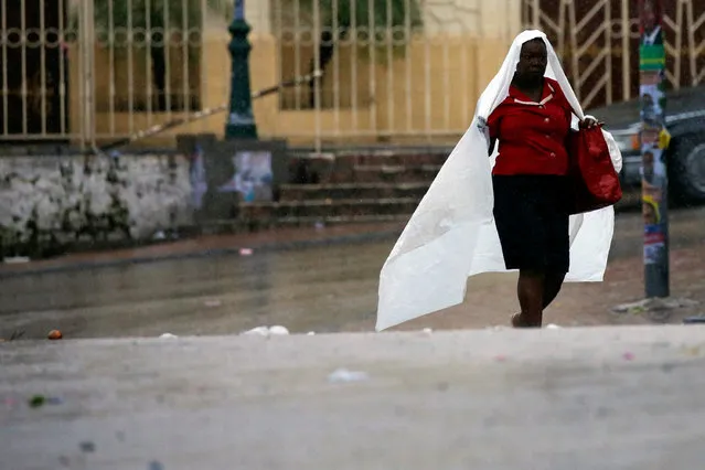 A woman walks down the street while Hurricane Matthew passes Port-au-Prince, Haiti October 4, 2016. (Photo by Carlos Garcia Rawlins/Reuters)