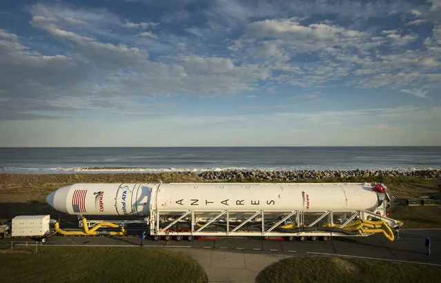 This image provided by NASA shows the Orbital ATK Antares rocket is rolled to launch pad Thursday, October 13, 2016 at NASA's Wallops Flight Facility in Wallops Island, Va. (Photo by Bill Ingalls/NASA via AP Photo)
