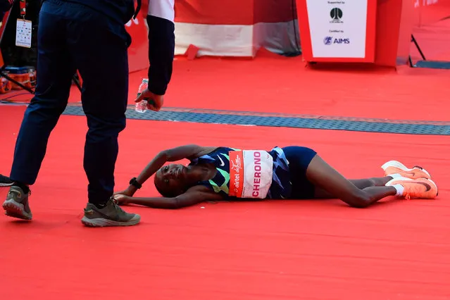 Kenyan athlete Gladys Cherono reacts after crossing the finish line of the women's 2020 Airtel Delhi half marathon in New Delhi on November 29, 2020. (Photo by Sajjad Hussain/AFP Photo)