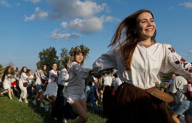Ukrainians dance around a bonfire while celebrating the traditional pagan holiday of Ivana Kupala, in Kyiv, Ukraine, 23 June 2024. Ivana Kupala is usually celebrated on the shortest night of the year, marking the beginning of summer. People sing and dance around bonfires, play games, and perform traditional rituals. (Photo by Sergey Dolzhenko/EPA/EFE)