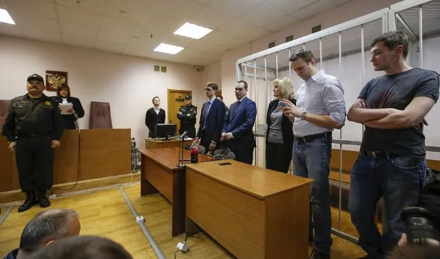 Russian opposition leader and anti-corruption blogger Alexei Navalny (2nd R) and his brother and co-defendant Oleg (R) attend at a court hearing in Moscow December 30, 2014. (Photo by Sergei Karpukhin/Reuters)