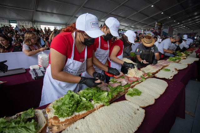 Staff members of restaurants prepare a 76-meter-long torta, as they attempt to establish a new world record, at the annual Torta Festival, Mexico on July 31, 2024. Staff members of several restaurants of the country, gathered at the annual Torta Festival to prepare a 76-meter-long torta, which is a Mexican sandwich filled with meat and various ingredients, in two minutes and ten seconds, breaking their last year record for the world's longest Torta. (Photo by Daniel Cardenas/Anadolu via Getty Images)