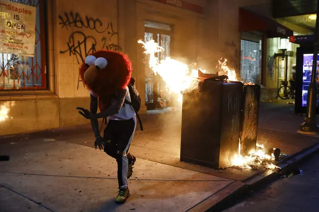 A protester in an Elmo mask dances during the Justice for George Floyd Philadelphia Protest on Saturday, May 30, 2020. Demonstrators took to the streets across the United States to protest the death of Floyd, a black man who was killed in police custody in Minneapolis on May 25. (Photo by Matt Rourke/AP Photo)
