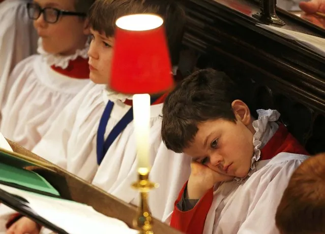 A choirboy sits in the pews during a service for the inauguration of the Tenth General Synod, at Westminster Abbey in London, Britain November 24, 2015. (Photo by Peter Nicholls/Reuters)