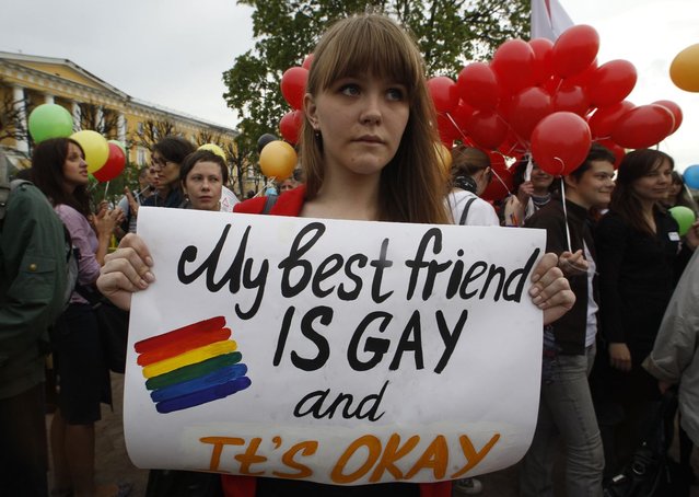 A gay rights activist holds a banner during a rally to mark international day against homophobia in St. Petersburg May 17, 2013. (Photo by Alexander Demianchuk/Reuters)