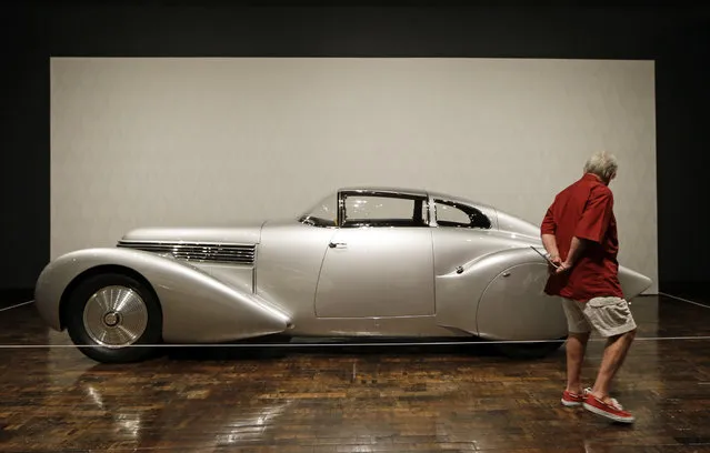 Tandy Culpepper views a 1938 Hispano-Suiza H6 Dubonnet “Xenia” Coupe on Friday, June 14, 2013, in Nashville, Tenn., as part of the “Sensuous Steel” exhibit at the Frist Center for the Visual Arts. The exhibit is made up of cars and motorcycles from the 1930s and 1940s that exemplify the elegance and styling characteristic of the Art Deco style. The exhibit is scheduled to run through September 15. (Photo by Mark Humphrey/AP Photo)