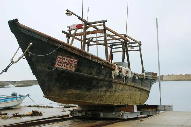 This November 29, 2015 photo shows a ship of unknown nationality in Wajima, Ishikawa prefecture, central Japan, after it was found in mid-November off Noto peninsula and was towed to the shore.  Japanese authorities are investigating nearly a dozen wooden boats carrying decomposing bodies found drifting off the northwestern coast over the past month. Coast Guard officials said Tuesday, Dec. 1, 2015. (Photo by Kyodo News via AP Photo)