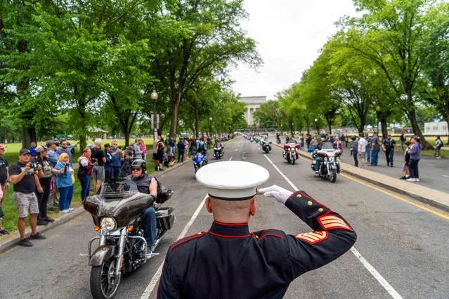 U.S. Marine Corp Staff Sgt. Tim Chambers salutes during the “Rolling to Remember” motorcycle rally, successor to “Rolling Thunder”, as it rides through to bring attention to issues faced by veterans, in Washington, U.S., May 28, 2023. (Photo by Bonnie Cash/Reuters)