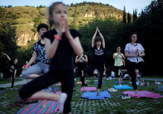People perform yoga on International Yoga Day in Tbilisi, Georgia on June 21, 2018. (Photo by David Mdzinarishvili/Reuters)