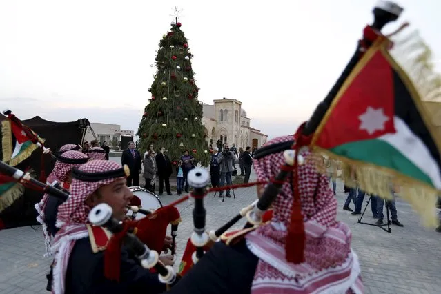 Members of a Jordanian police band perform during a celebration of the lighting of a 12-metre-tall Christmas tree at a Lutheran Church, which stands on a baptism site on the Jordan River, in Shouneh, Jordan December 13, 2015. (Photo by Muhammad Hamed/Reuters)