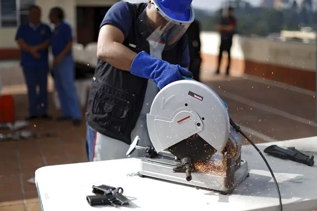 A seized weapon is destroyed by the authorities of the General Directive for the Control of Weapons and Munitions, (DIGECAM), in Guatemala City, December 17, 2015. (Photo by Jorge Dan Lopez/Reuters)