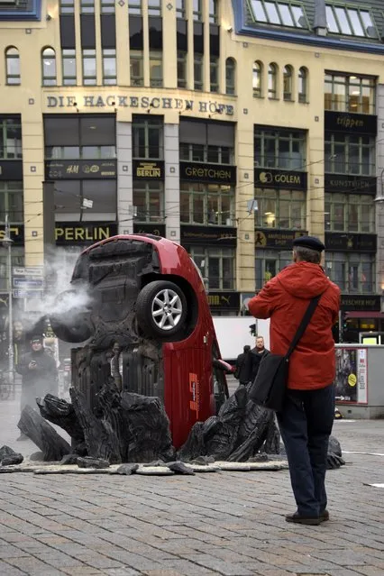 A car “crashed” into the ground at Hackescher Markt in Berlin, Germany on November 15, 2016, ahead of the launch of Jeremy Clarkson, Richard Hammond and James May's new show, “The Grand Tour”, on Amazon Prime Video, on Friday. (Photo by Clemens Bilan/Getty Images for Amazon Prime Video)