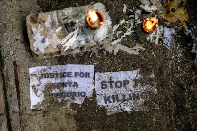 Candles are lit on the spot where mother and son Sonya and Frank Anthony Gregorio were shot and killed by an off-duty police officer, on the day of their funeral, in Paniqui, Tarlac province, Philippines, December 27, 2020. (Photo by Eloisa Lopez/Reuters)