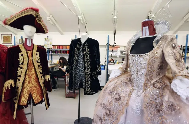 An assistant of costume designer Stefano Nicolao works on a creation in his atelier in downtown Venice January 31, 2015. (Photo by Stefano Rellandini/Reuters)