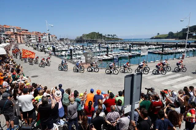 The pack of cyclists ride through Lekeitio, Spain, 03 July 2023, during the third stage of the Tour de France 2023, a 193,5km race from Amorebieta-Etxano in Spain to Bayonne in France. (Photo by Miguel Tona/EPA/EFE)